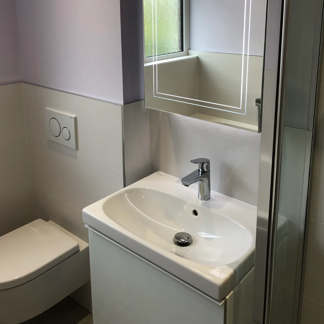 White Sink in Lilac bathroom renovation with illuminated mirror